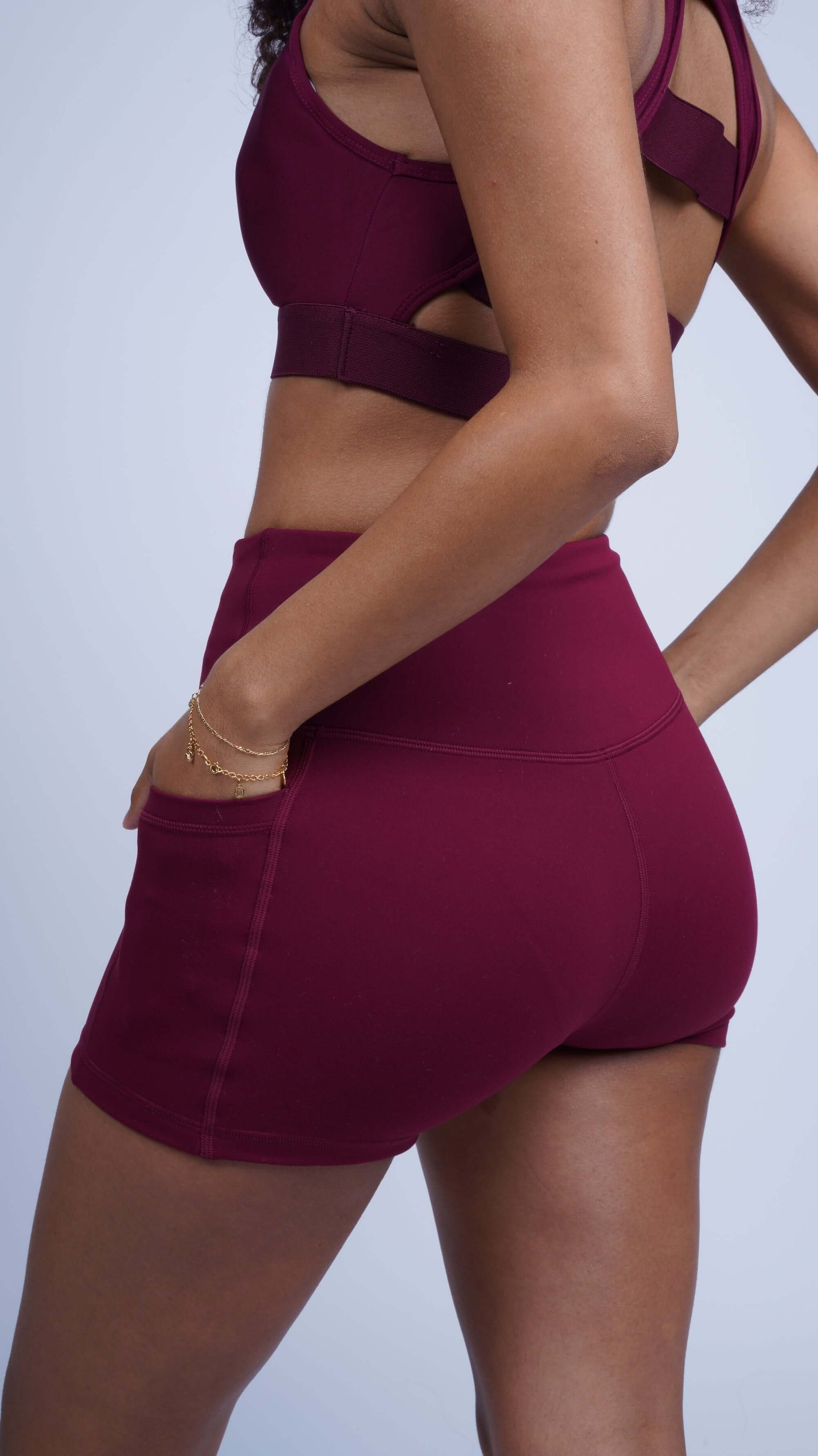 Model wearing burgundy three pocket basic shorts with high waistband, showcasing breathable, stretchy material.